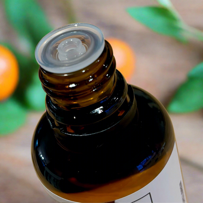 Amber glass essential bottle with close up of the top to show the dropper