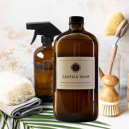 Castile Soap in amber glass bottle with amber glass spray bottle and bamboo dish scrub brush