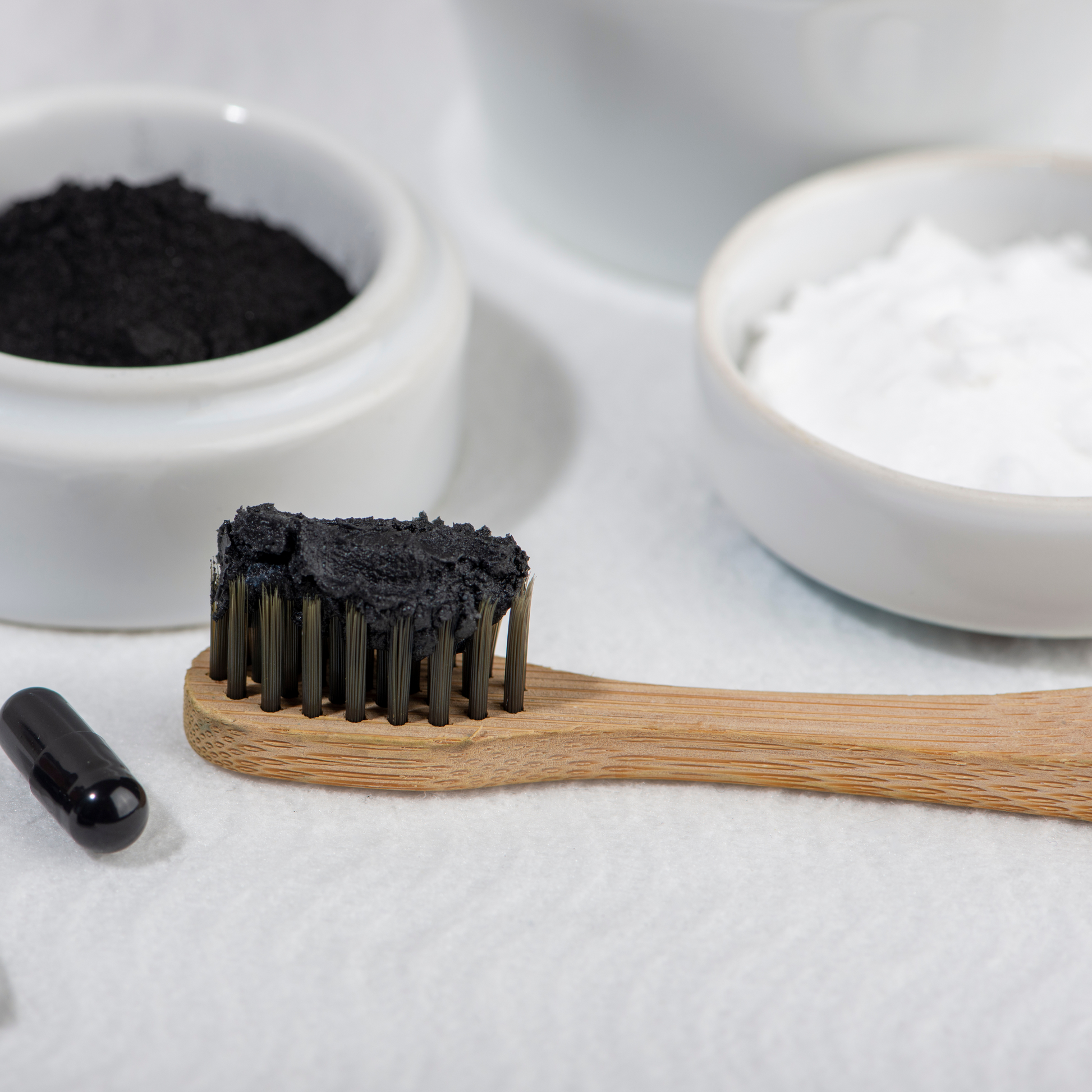 A toothbrush with charcoal and bicarb for homemade toothpaste
